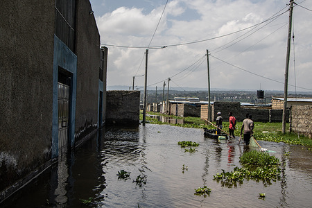 People seen fishing on a submerged field following the rising water levels of Lake Naivasha in Nakuru County. Rising levels of Lake Naivasha have displaced over 5,000 people in Kihoto Estate, approximately 90 km Northwest of Nairobi, Kenya's capital. Their homes were submerged following increased rainfall over the past two months, with experts linking the rise to climate change. Kenya Meteorological Department has predicted more rains will continue falling and the flooding situation may escalate. As the world celebrates World Oceans Day, the threat of climate change to people living in catchment areas is real.