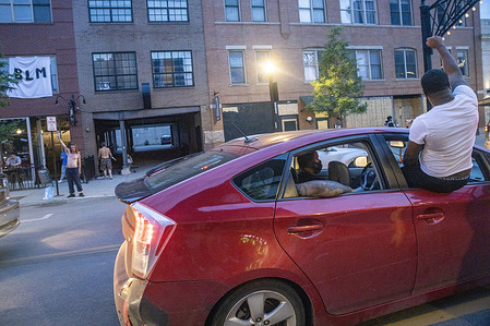 A protester hanging out of the car window raises his fist in solidarity with the BLM movement during the demonstration.
Protesters gathered in front of the Ohio Statehouse and marched north on High St. in a demonstration against police brutality, racism and the killing of George Floyd by Minneapolis Police Officer Derek Chauvin on May 25, 2020.