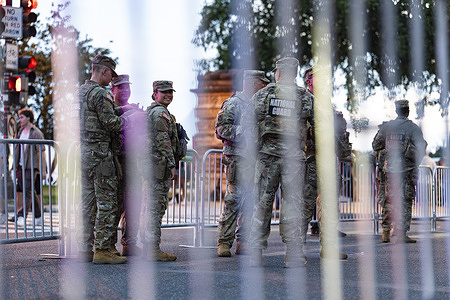 National Guard troops patrol the streets ahead of a UFC fight on the South Lawn of the White House, Sunday, June 14, 2026, in Washington.