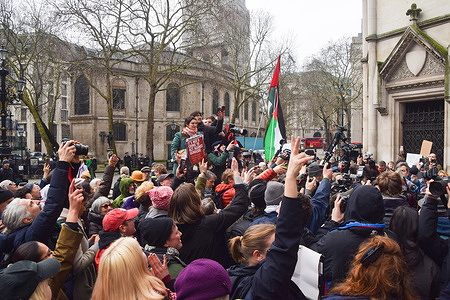 Supporters celebrate outside the Royal Courts of Justice following the High Court ruling that the ban on Palestine Action is unlawful. The activist group was banned in the UK under terrorism laws.
