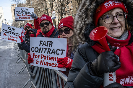 Nurses on the picket line try to keep warm in front of Mt. Sinai hospital. Despite the frigid temperatures , the nurses strike continues as the try to reach an agreement for their pay and health benefits with the administrators at Mount Sinai Hospital, Mt. SInai Morningside and West, as well as New York- Presbyterian.