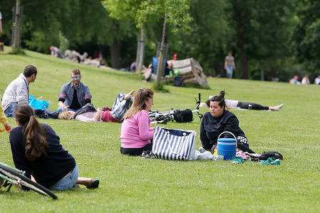People enjoying the warm weather in Finsbury park during the COVID-19 lockdown as they observe social distancing.
The government has relaxed the restrictions on coronavirus lockdown to allowing people to spend more time outside.
