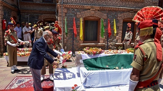 A policeman seen laying a floral wreath on the coffin containing the body of slain police inspector Arshad Khan during a wreath-laying ceremony in Kashmir.
A wreath-laying ceremony was held for the slain police inspector Arshad Khan, who succumbed to his injury on Sunday. He was critically injured in a militant attack in Anantnag of south Kashmir on June 12. Five CRPF personnel were also killed in the attack, when a militant targeted a patrolling team of the forces.