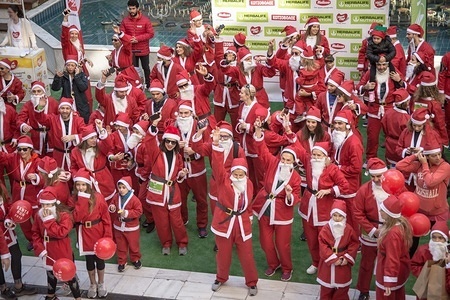 Participants Wearing Santa Claus costumes are seen before the annual Santa Run.
Hundreds of people Wearing Santa Claus costumes participate at the annual Santa Run in Athens.