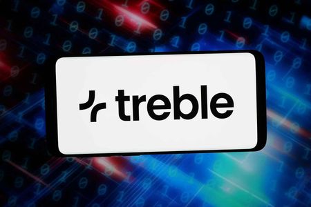 In this photo illustration, the logo of sound simulation company Treble Technologies is displayed on a smartphone in front of abstract background on computer screen.