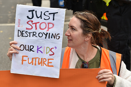 A protester holds a placard expressing her opinion during the seated in protest opposite Downing Street at Whitehall. Climate activists group Just Stop Oil protest on the 7th day of Occupy Westminster action, demanding to halt all future licensing and consents for the exploration, development and production of fossil fuels in the UK.
