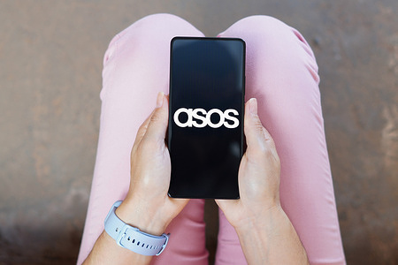 In this photo illustration, the ASOS logo is displayed on a smartphone screen.