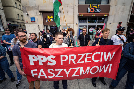 Polish antifascist protesters stand with a banner against fascism. On the afternoon of Saturday, far-right groups the All-Polish Youth and the Independence March gathered outside the European Parliament offices marching under the banner, "Poland for Poles, Poles for Poland". Across the street, antifascist demonstrators congregated to protest the gathering and the racist, anti-immigration sentiments expressed.
