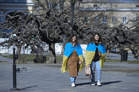 Girls wrapped with Ukrainian flags walk in the city centre. The center of Odessa and the Odessa Opera and Ballet Theater had been protected with sandbags and anti-tank barriers, Fearing a Russian attack from the Black Sea, the city residents try to defend the city and its monuments.