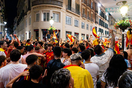 Spanish fans seen waving flags as they celebrate Spain's FIFA World Cup victory over Argentina at Marques de Larios street.