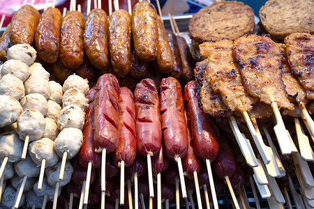 A selection of grilled pork meat sausages including Sai Krok Isan and Moo Ping, satay style meat on a stick a popular Thai street food sold from stalls and markets. Bangkok, Thailand, is widely considered the street food capital of the world, with countless stalls offering a wide variety of culinary delights.