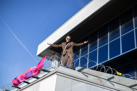 A protester chants slogans while making gestures during demonstration on the rooftop at London City Airport.
Extinction Rebellion protesters plan to cause chaos at the London City airport for three days to raise awareness of the climate emergency.
