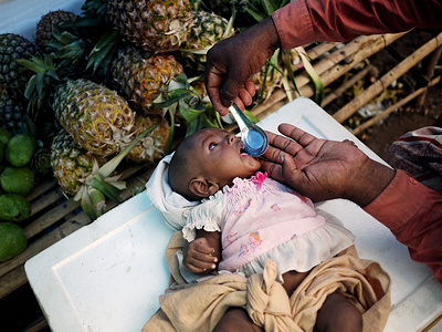 A Karen baby is spoon fed by her mother at a local store selling pineapples.
Karen people have been facing war and violence for many years. They started their war for independence in 1949. A consequence of a cruel civil war with the Burmese government is that many people were internally displaced or ran to foreign countries, mostly Thailand. But Thailand does not recognize them as refugees. They are not allowed to work there officially or to leave the refugee camps, usually set in the middle of jungle.
In recent years, the situation of Karen ethnic group is getting to better. They signed ceasefire with Burmese government. But there are more fractures and some armed groups don´t want to stop fighting until the independence will be reached.