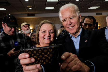 FORT MADISON, UNITED STATES - JANUARY 31 2020: Former Vice President and Democratic presidential candidate, Joe Biden takes selfies with his supporters during a campaign stop in Fort Madison several days before the Iowa Caucus.