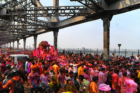 God Satyanarayan seen driven around in a vintage Rolls Royce during the Holi festival celebration. Holi also known as the festival of colors is celebrated to mark the arrival of spring.
