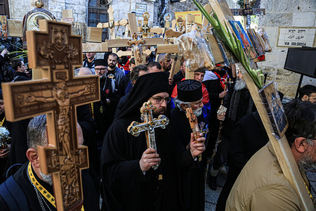 Orthodox Christians carry wooden crosses along the Via Dolorosa (Way of Suffering) in the Old City of Jerusalem during the Orthodox Good Friday procession before Holy Saturday tomorrow. Christian pilgrims took part in processions along the way as, according to tradition, Jesus Christ carried the cross on his last day before his crucifixion.