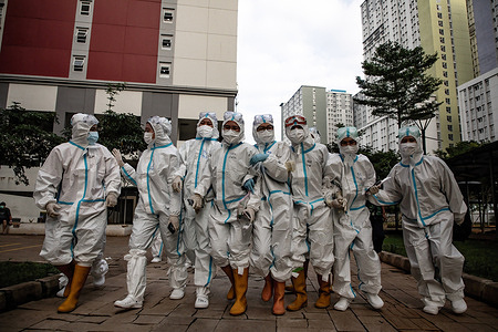 Health workers wearing Personal Protective Equipment are seen inside the Wisma Atlet Covid-19 Emergency Hospital complex.The Wisma Atlet Covid-19 Emergency Hospital with 7,394 beds is almost 90% filled up. Indonesia has experienced a significant spike in COVID-19 cases after the Eid holiday during the past month. The number of Covid-19 cases has crossed two million.