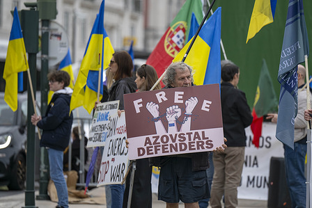 Protesters hold flags and placards during the demonstration. Ukrainian citizens held a demonstration in downtown Lisbon, calling for peace and urging the international community to take stronger action to help end the war.