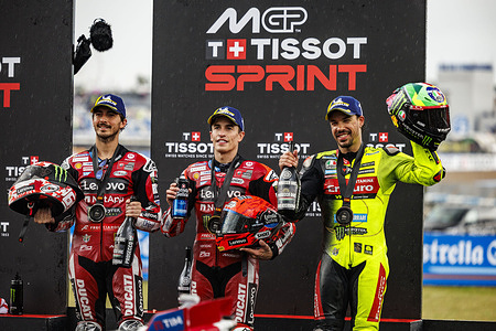 Number 93 Ducati Lenovo Team rider Marc Marquez, Number 63 Ducati Lenovo Team rider Francesco Bagnaia, Number 49 Pertamina Enduro VR46 Racing rider Fabio Di Giannantonio celebrate being on the podium after the sprint race at the 2026 Estrella Galicia 0,0 Grand Prix of Spain