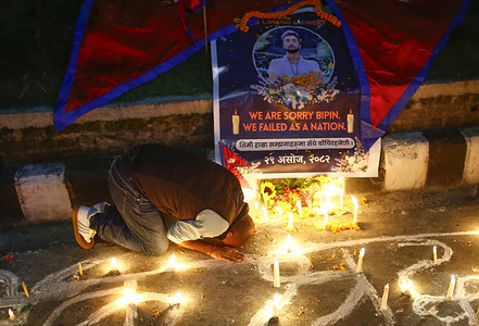 A mourner bows before the photo of Bipin Joshi, a young Nepali student who was held hostage in Gaza and confirmed dead after two years in captivity, during a candlelight vigil. Bipin Joshi was abducted in October 2023 while participating in a study program in Israel and is remembered as the only Nepali whose fate remained uncertain for an extended period following the Hamas attack. The vigil was held to honour his memory and mourn the loss of a brave son of Nepal.