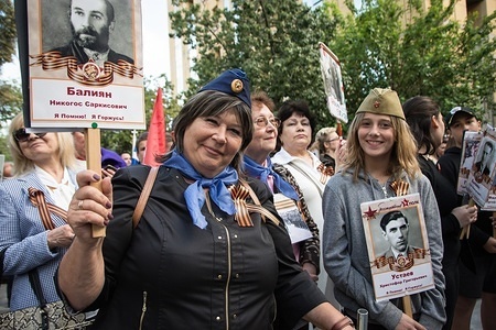 Participants seen holding pictures during the celebrations.
Thousands of Russian citizens participated in the celebrations for the anniversary of the victory against fascism, which has been established as a Victory Day. With the military parade as well as the demonstration, the festive event took place across Russia, with citizens holding photos of their relatives who have either fought or been killed during the World War.