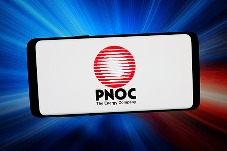 In this photo illustration, the Philippine National Oil Company (PNOC) logo is seen displayed on a smartphone in front of abstract background on computer screen.
