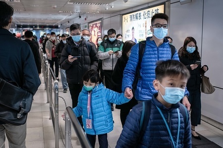 Commuters wear masks while crossing Kowloon Tong MTR Station.
The World Health Organization called a global health emergency, reversing earlier decision on coronavirus outbreak. So far there are 13 confirmed cases of the coronavirus in Hong Kong, while the total confirmed cases has jumped to 14,549 and the death toll has risen to 305.