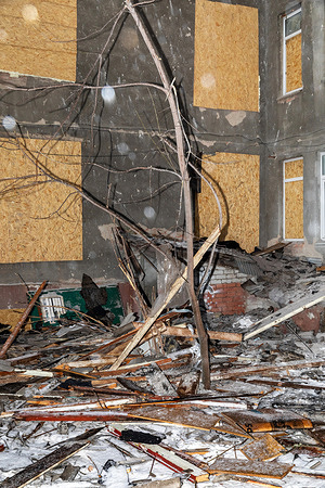 Rubble and shattered wood are seen covering the floor of a residential building in Kharkiv. Windows boarded with plywood are seen in the damaged room resulting from a bombing. Kharkiv continues to record the aftermath of massive bombardments on residential districts. Direct hits from aerial bombs and missile strikes have turned dozens of multi-story buildings in residential neighborhoods into ruins, with entire sections collapsed and social infrastructure destroyed. City services and international experts are documenting each instance of destruction as a war crime against the civilian population. Despite the constant risk of repeated attacks, emergency repair work continues in less damaged buildings; however, thousands of Kharkiv residents remain homeless, awaiting the city’s large-scale reconstruction once hostilities end.