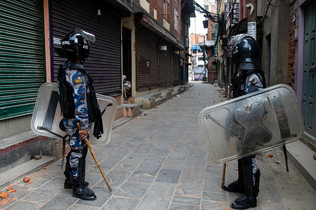 Riot policemen stand on guard at Patan Durbar Square street during the curfew.
The District Administration Office, Lalitpur has imposed a day long curfew in Lalitpur district after devotees and riot police clashed during the start of the of the Rato Machindranath chariot procession on Thursday.