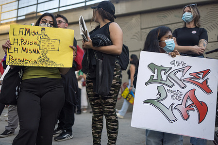 Protesters hold placards demanding “ICE Out of LA” during a National Day of Action outside the Metropolitan Detention Center in Los Angeles, California.