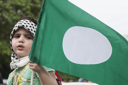 A foreign child seen at the demonstration as she holds one of a Malaysian Islamic political party (PAS) flag.
Almost 1000 people gathered outside the United State Embassy at Kuala Lumpur after the Friday prayer to protest against President Donald Trump's recognition of Jerusalem as Israel's capital city.
