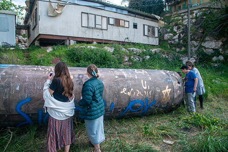 Jewish youths write slogans on a missile fragment. A huge fragment of an Iranian ballistic missile, landed in an Israeli Jewish settlement in central Israel, without causing any damage or casualties.
