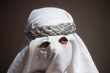 A penitent from 'Gitanos' brotherhood poses for a photo as he takes part in a procession on Holy Monday to mark the Holy Week celebrations. Thousands of worshippers wait to see the processions with the statues of Christ and the Virgin Mary as part of the traditional Holy Week celebrations. In Andalusia, Easter brings together thousands of people from all over the world and it's considered one of the most important religious and cultural events of the year.