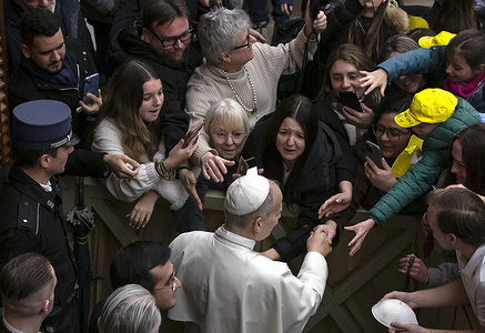 Pope Leo XIV greets the faithful at the end of his weekly general audience in the Paul VI hall at the Vatican.