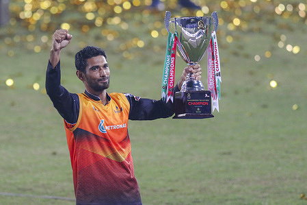 Gemcon Khulna cricket player Mahmudullah holds a trophy during the Bangabandhu T20 Cup 2020 Final between Gazi Group Chattagram and Gemcon Khulna at the Sher-e-Bangla National Cricket Stadium in Dhaka.