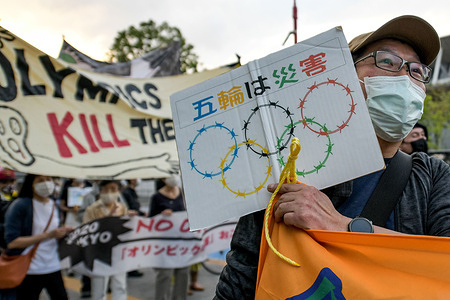 Protesters carry banners and placards as they demonstrate against the Tokyo Olympics in front of the New National Stadium, the main stadium for the Tokyo Olympics.With less than 3 months remaining until the opening of the Tokyo 2020 Olympics concern continues to linger in Japan over the feasibility of hosting such a huge event during the ongoing COVID-19 pandemic.