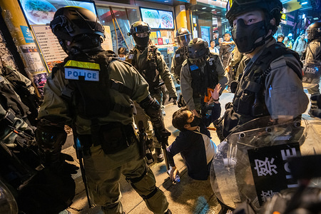 Police officers arresting a protester during the unrest.
Anti-government protesters rallying on Christmas Eve in Hong Kong continue their demands for an independent inquiry into police brutality.