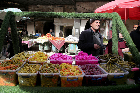 A Palestinian vendor sells pickled cucumbers, olives, and carrots in the Old City of Nablus in the West Bank on the eve of the holy month of Ramadan. For Muslims worldwide, the beginning of the ninth month of the Islamic calendar, which marks the start of Ramadan, is a time for spiritual reflection, prayer, fasting, and family gatherings around the iftar table.