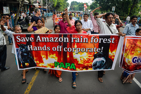 Protesters chant slogans while holding a banner during the protest against the devastating wild fire in amazon and highlighting qualms about the controlling policies taken up by the Brazilian President Jair Messias Bolsonaro.
The raging fires burning down massive stretches of Amazon rain-forest, have intensified through August 2019 threatening the life of multitudes. Among the 80000 fires so far this year, this is recorded to be the deadliest by the country's National Institute for Space Research (INPE).