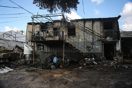 A view of a burned-out building and greenhouse set ablaze by Jewish settlers in the town of Deir Sharaf.