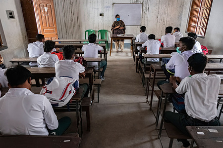 Students in Madhyamgram high school of class 9 to12 attending a physical class during the school reopen.Madhyamgram high school reopens amid coronavirus pandemic In Kolkata, students maintain social distance as a mandatory rule by Govt.