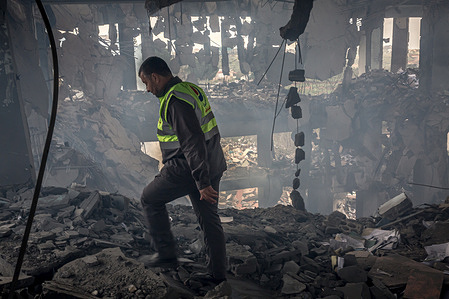 A man wearing the logo of the Hezbollah-linked Islamic Health Organisation walks through the remains of a health centre in Bourj Qalaway, following an Israeli attack. At least 850 people in Lebanon have been killed since Israel and Hezbollah returned to all-out war, including 32 healthcare workers, according to Lebanon's Ministry of Health.