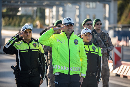 Police officers stand in silence at 09:05 a.m to commemorate the death time of Mustafa Kemal Ataturk, founder of the Republic of Turkey, on the 85th anniversary of his demise at July 15th Martyrs Bridge in Istanbul.
