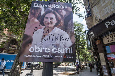 An electoral poster of the mayor and candidate for re-election Ada Colau seen vandalized with phrases about her management.