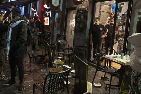 The aftermath of the scene after tables were tipped outside the "Miznon" restaurant on Hardware Lane. Protesters targeted a restaurant on Hardware Lane as it is owned by the spokesman of a controversial Israeli aid group working in Gaza.