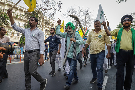 A Sikh activist holds a plow while chanting slogan during the demonstration staged by the Samyukt Kisan Morcha against the newly imposed farm laws by the Indian government.