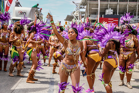Participants dressed in colorful costumes at the Toronto Caribbean Carnival Grand Parade, a festival of Caribbean culture and traditions held each summer.