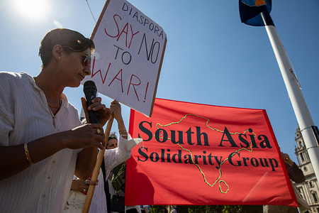 A member of the South Asian Group holds an anti war placard during a rally. With tensions escalating between India and Pakistan, members of the British South Asian Group held a peace rally in Parliament Square, Westminster, London.