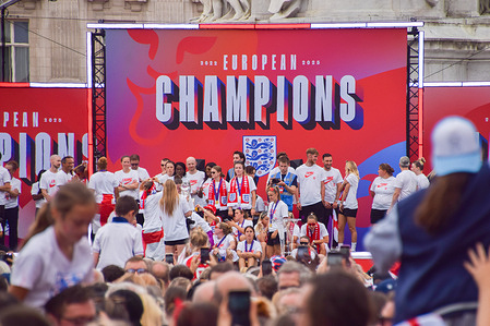 The England women's national football team, known as the Lionesses, celebrate their Euro 2025 win on a stage at the Victoria Memorial outside Buckingham Palace following an open-top bus parade. England defeated Spain 3-1 on penalties.