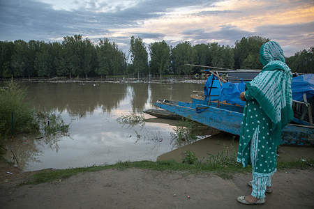 Kashmiri woman watches rising water levels of River Jhelum on the outskirts of Srinagar. An imminent flood threat looms over Jammu and Kashmir as rivers and streams swell after continuous rainfall. Authorities have closed all schools and shut the Srinagar-Jammu national highway, the only road link connecting the Kashmir Valley with the rest of India. The local meteorological department forecasts heavy to very heavy rain in the next 24 hours. Residents have been urged to stay vigilant and take precautions due to the heightened risk of landslides and floods.